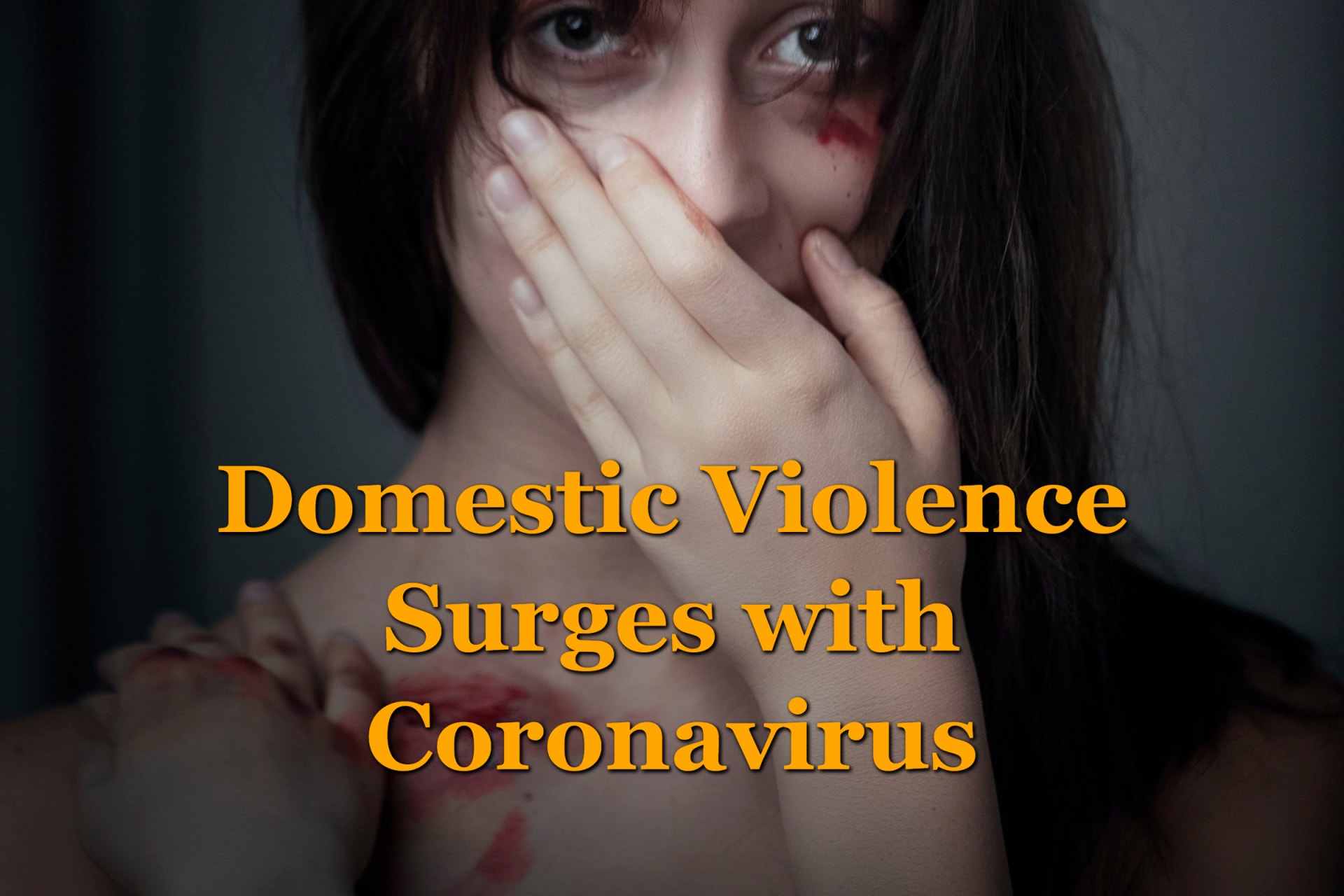 A woman, a victim of domestic violence surges during coronavirus lockdown with her hand over her mouth.