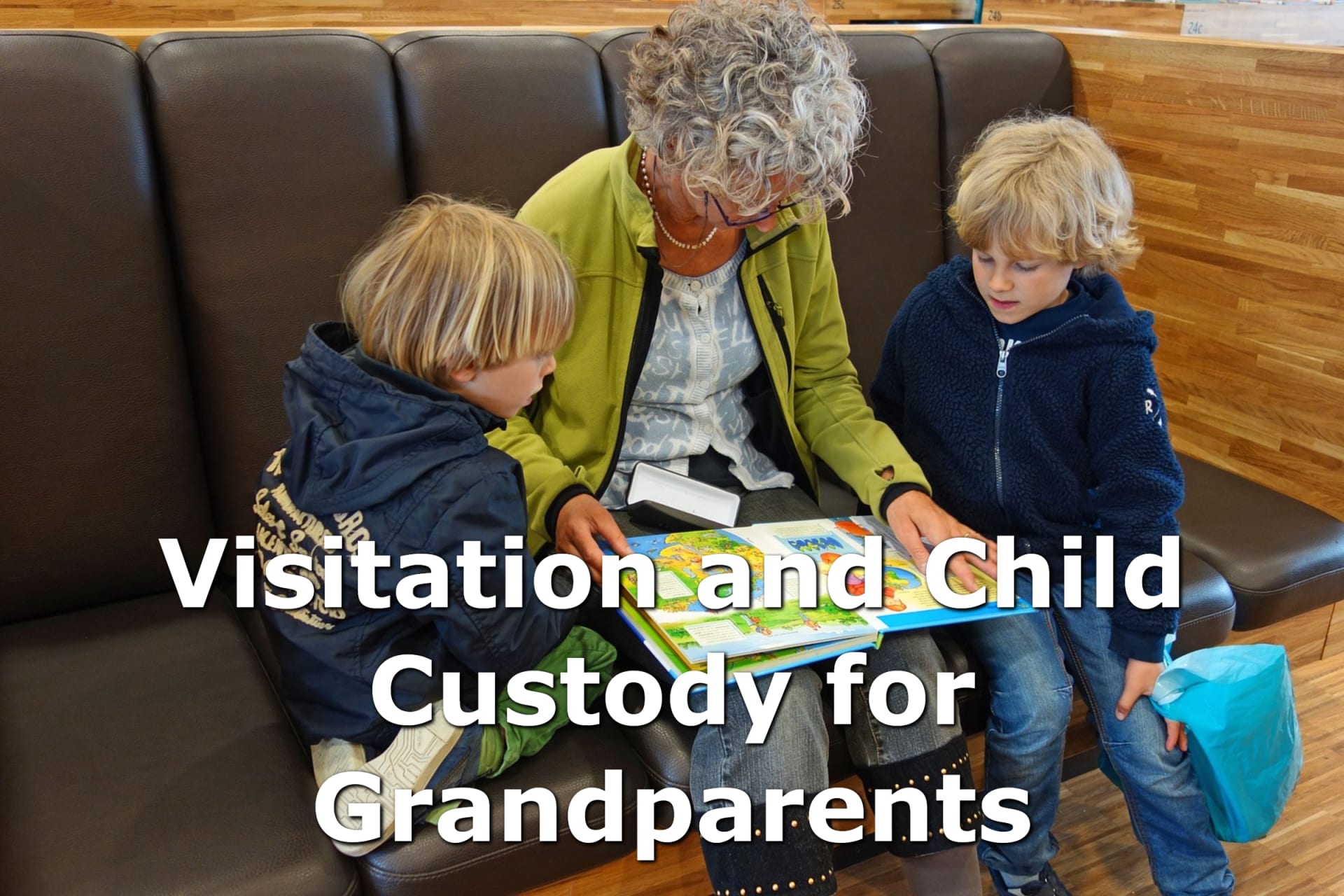 An older woman with gray hair and a green jacket reads a children's book to her two grandchildren with blonde hair. The legal custody law that's fit for everyone is Ilarraza Law. Our family law firm specializes in custody for grandparents, providing a quick and affordable process that allows you to legally protect your grandchildren's future as soon as possible.